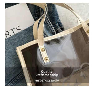 Detail view of transparent PVC tote bag with cream leather trim and gold rivet accents