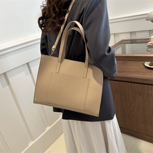 Beige checkered tote bag with large pocket shown as an elegant shoulder bag