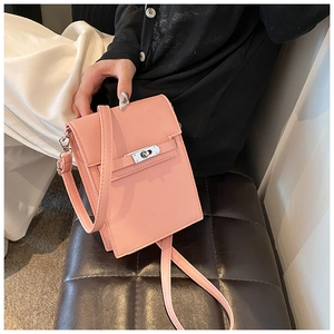 Detailed view of pink lychee leather mini square phone bag with silver metal twist lock