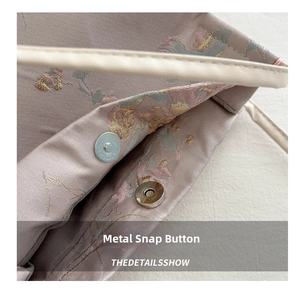 Detail of premium silver magnetic hardware closure on lavender floral embroidery bag