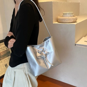 Chic silver metallic underarm bag with decorative lacing and sleek shoulder strap