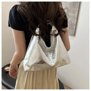 Silver metallic shoulder bag with embossed logo lettering and soft textured finish