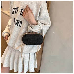 Elegant black sequin clutch bag with golden metal ring handle and long chain strap