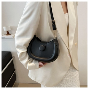 Minimalist black semi-circle saddle bag with adjustable strap and golden hardware