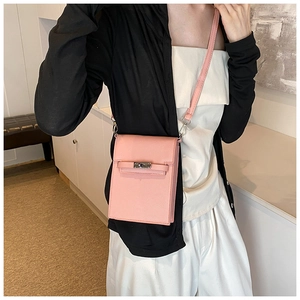 Pink Saffiano leather phone crossbody bag with silver turn-lock clasp worn by model