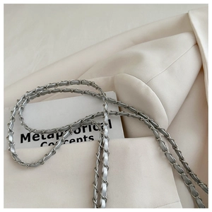 Detailed close-up of the silver metal chain interwoven with premium leather on a bucket bag