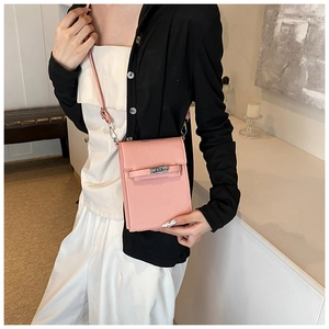 Detail of pink leather vertical crossbody phone bag with classic silver metal turn-lock