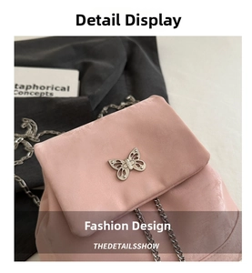 Close-up of pink velvet backpack featuring silver butterfly clasp and chain strap