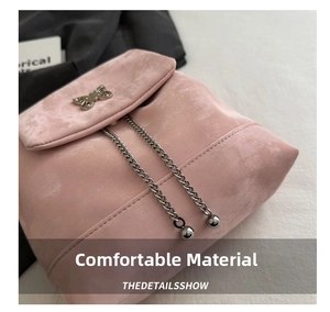 Detail of pink suede backpack featuring silver butterfly clasp and chain drawstrings