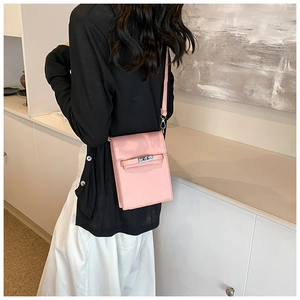 Detail of pink PU leather mini square bag with elegant metal lock on a model back