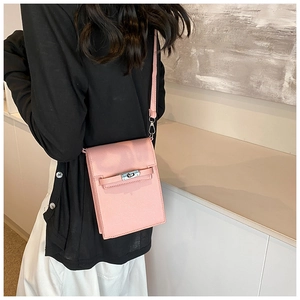 Close-up of pink leather vertical mini bag with silver buckle and crossbody strap