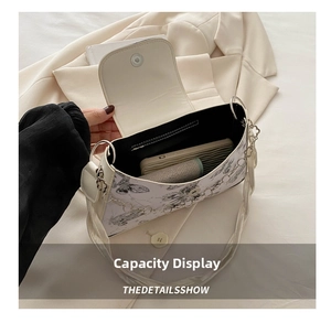 Detail view of small crossbody bag showing interior capacity for phone and cosmetics