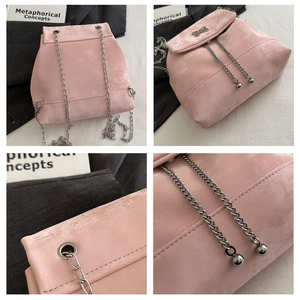 Detailed views of pink suede backpack with silver chain and butterfly metal ornament