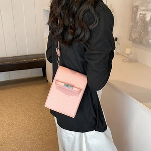 Pink mini crossbody phone bag with silver metallic clasp and slim leather strap