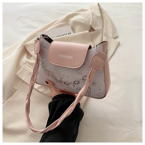 Close-up of pink crossbody bag with butterfly prints and heart metal chain detail