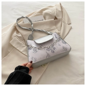 Detail of silver lavender shoulder bag with butterfly print and floral metal chain