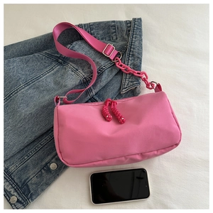 Pink waterproof nylon crossbody bag with chunky plastic chain and adjustable fabric strap