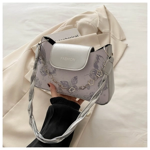Detail of silver metallic PU shoulder bag with purple butterfly print and floral chain