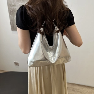 Silver metallic tote bag with chain strap and embossed logo for stylish women