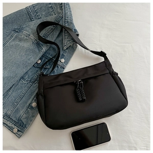 Détail du sac bandoulière noir en nylon avec doubles zips et sangle ajustable