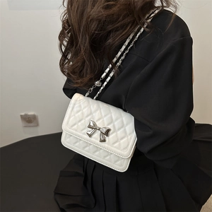 Chic white quilted crossbody bag with silver bow accent and elegant chain strap for women