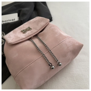 Detail of pink suede backpack with metal butterfly clasp and silver chain drawstrings