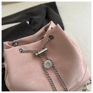 Detail of pink suede bucket bag with silver chain drawstring and magnetic closure