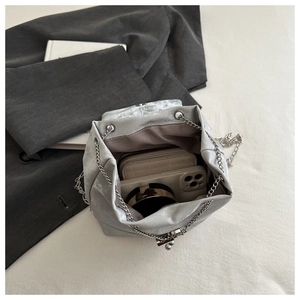 Interior view of silver chain backpack showing large capacity for phone and wallet