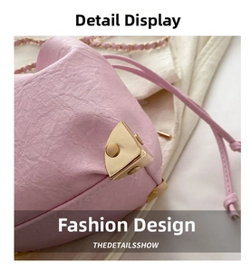 Close-up of pink bucket bag showing gold triangle metal buckle and textured leather