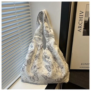 Close-up of butterfly print fabric with raw edge details on a white hobo tote bag