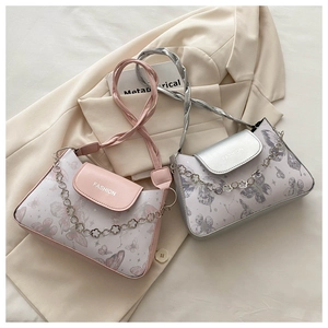 Detailed view of butterfly-patterned crossbody bags with stylish floral metal chain straps