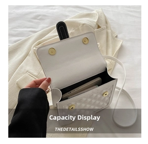 Detailed interior view of white quilted crossbody bag showing smartphone storage capacity
