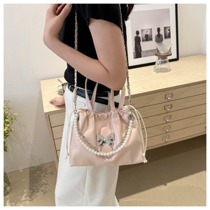 Detail of light pink drawstring bucket bag with silver butterfly and pearl chain strap