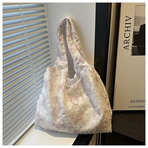 Close-up of white canvas tote bag with pink butterfly jacquard and frayed edge textures