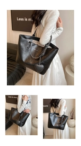 Close-up of black tote bag with vintage wrinkled texture and heart-shaped charm