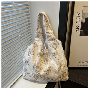 Close-up of vintage butterfly print on canvas tote bag with unique frayed edge detail