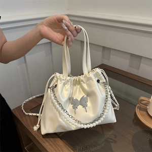 Elegant cream drawstring bucket bag with pearl chain and liquid metal butterfly
