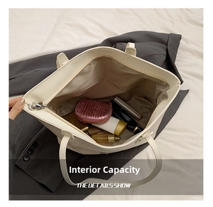 Detailed interior view of a large capacity cream leather tote bag with various accessories
