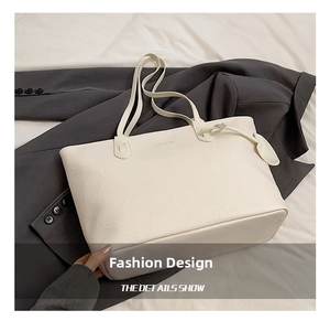 Detail showing the creamy white PU leather texture and shoulder straps of the tote bag