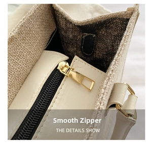 Detail shot of smooth gold zipper and premium canvas leather stitching on the tote bag