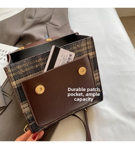 Detail view of the durable inner pocket and magnetic snap closure of the plaid handbag
