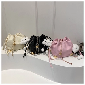Chic drawstring bucket bags in black, white, and pink with cloud plush charms and gold chains