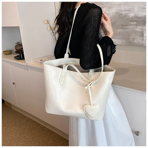 Off-white oversized tote bag with pleated texture and heart charm shown on model