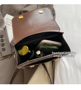 Internal view of the brown leather crossbody bag showing spacious storage for phones