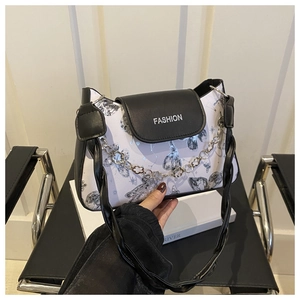 Detail of contrast shoulder bag with ink butterfly pattern and silver metal chain strap