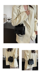 Detail showing wave-edge flap and bow decoration on the black crossbody chain bag