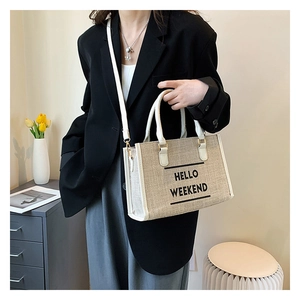 Minimalist canvas tote bag with 'Hello Weekend' print and faux leather trim detail