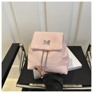 Detail of pink faux suede backpack featuring a silver butterfly clasp and chain drawstring