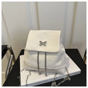 Detail of white suede backpack with silver butterfly metal clasp and chain drawstring