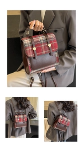 Detailed close-up of British style plaid backpack showing leather handle and gold hardware